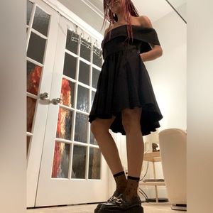 Black off the shoulder dress with pockets reminiscent of Wednesday Addams